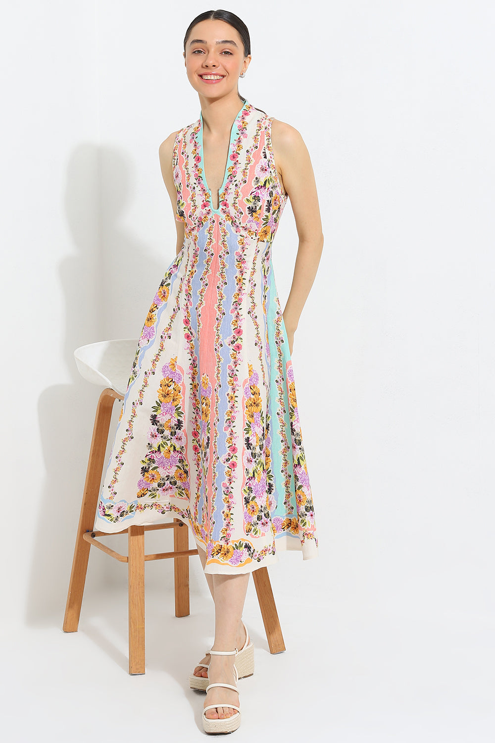 Simran Luthria in Aviva Halter Fit Flare Midi Dress