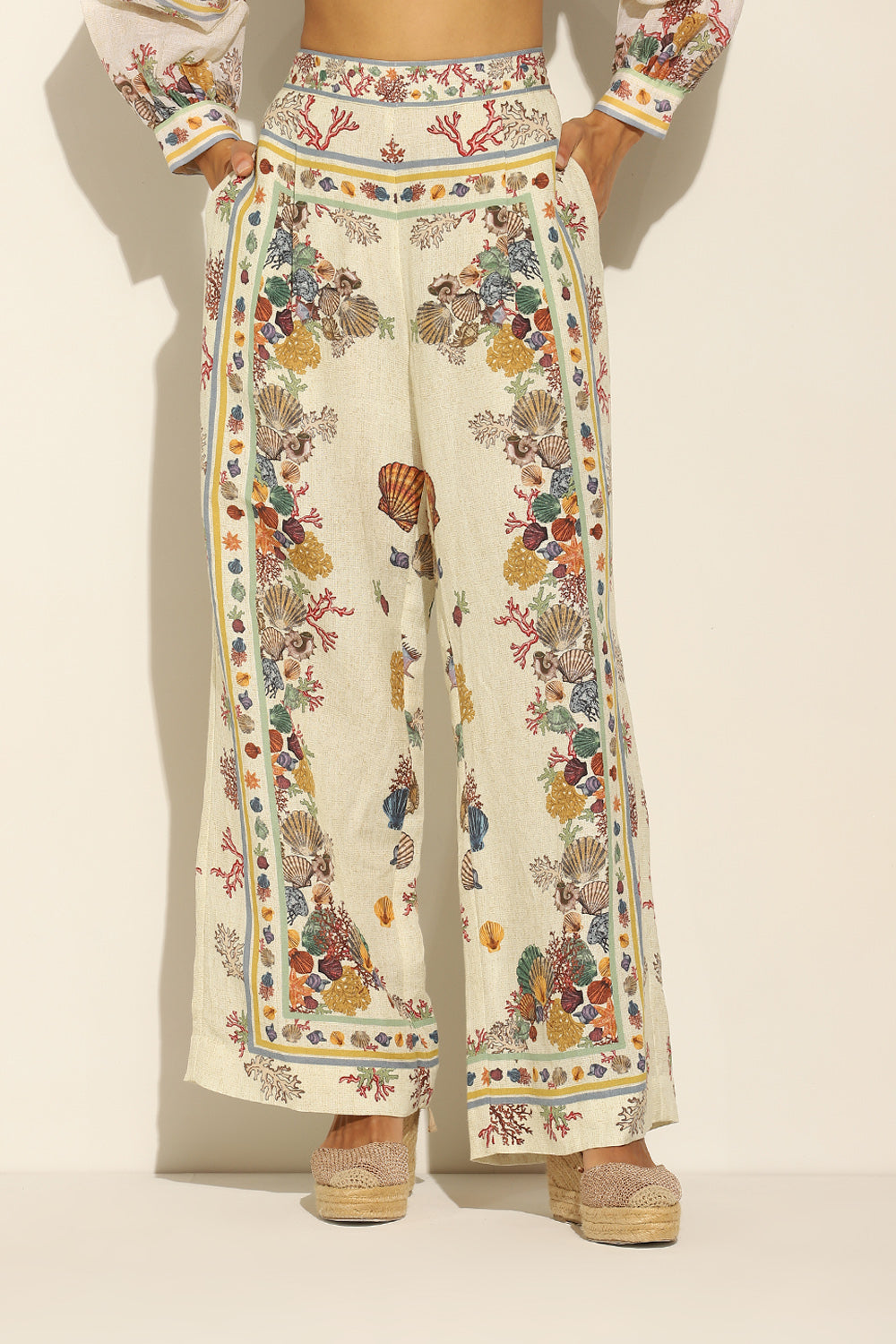 Ivory Wide Leg Pants by ranna gill with a floral and seashell pattern.