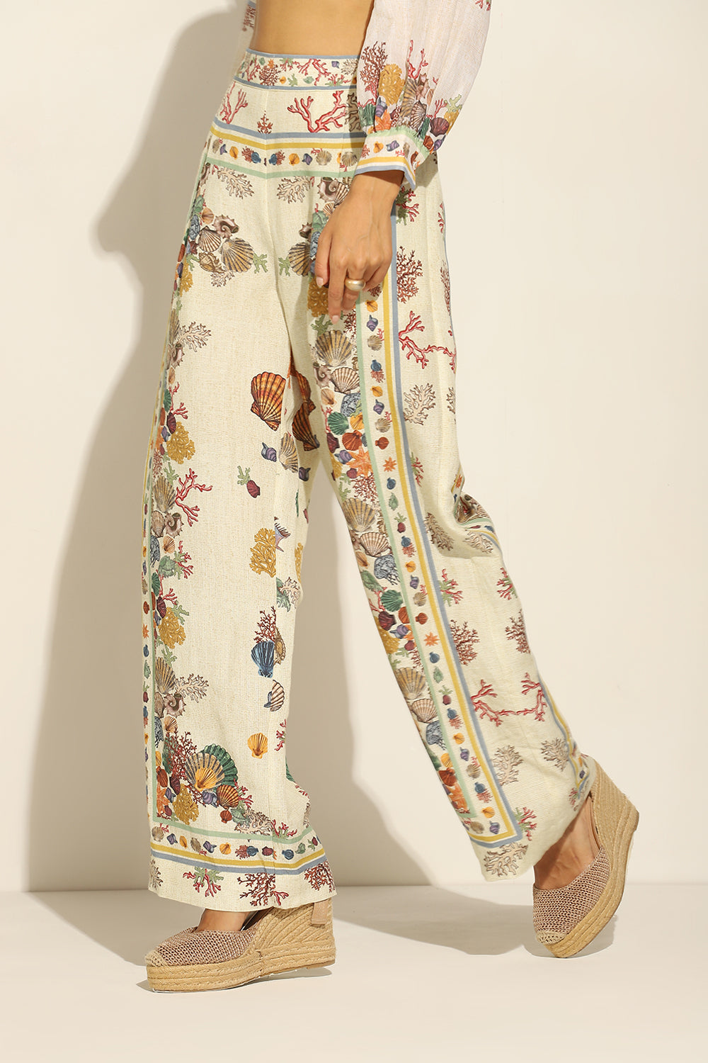 Ivory Wide Leg Pants by ranna gill with a floral and seashell pattern.