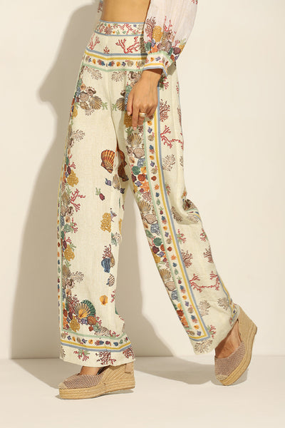 Ivory Wide Leg Pants by ranna gill with a floral and seashell pattern.