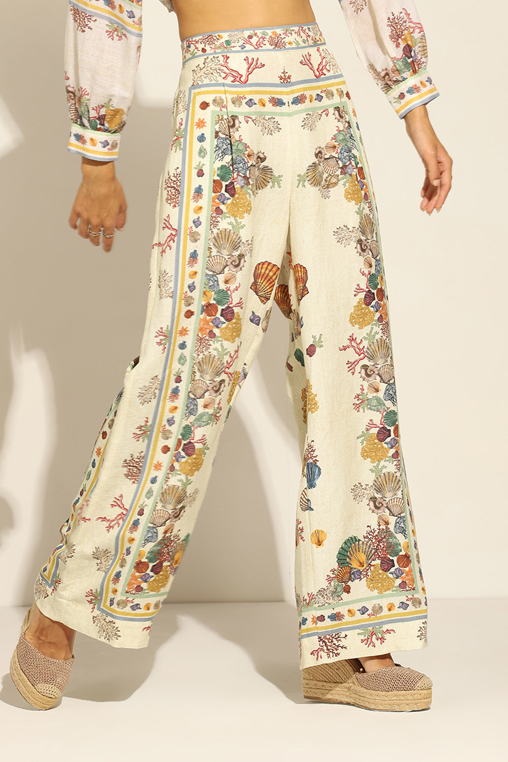 Ivory Wide Leg Pants by ranna gill with a floral and seashell pattern.