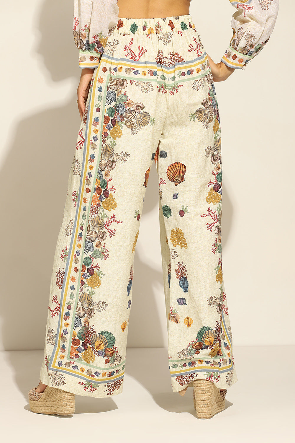 Ivory Wide Leg Pants by ranna gill with a floral and seashell pattern.