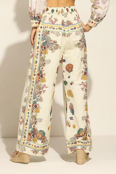 Ivory Wide Leg Pants by ranna gill with a floral and seashell pattern.