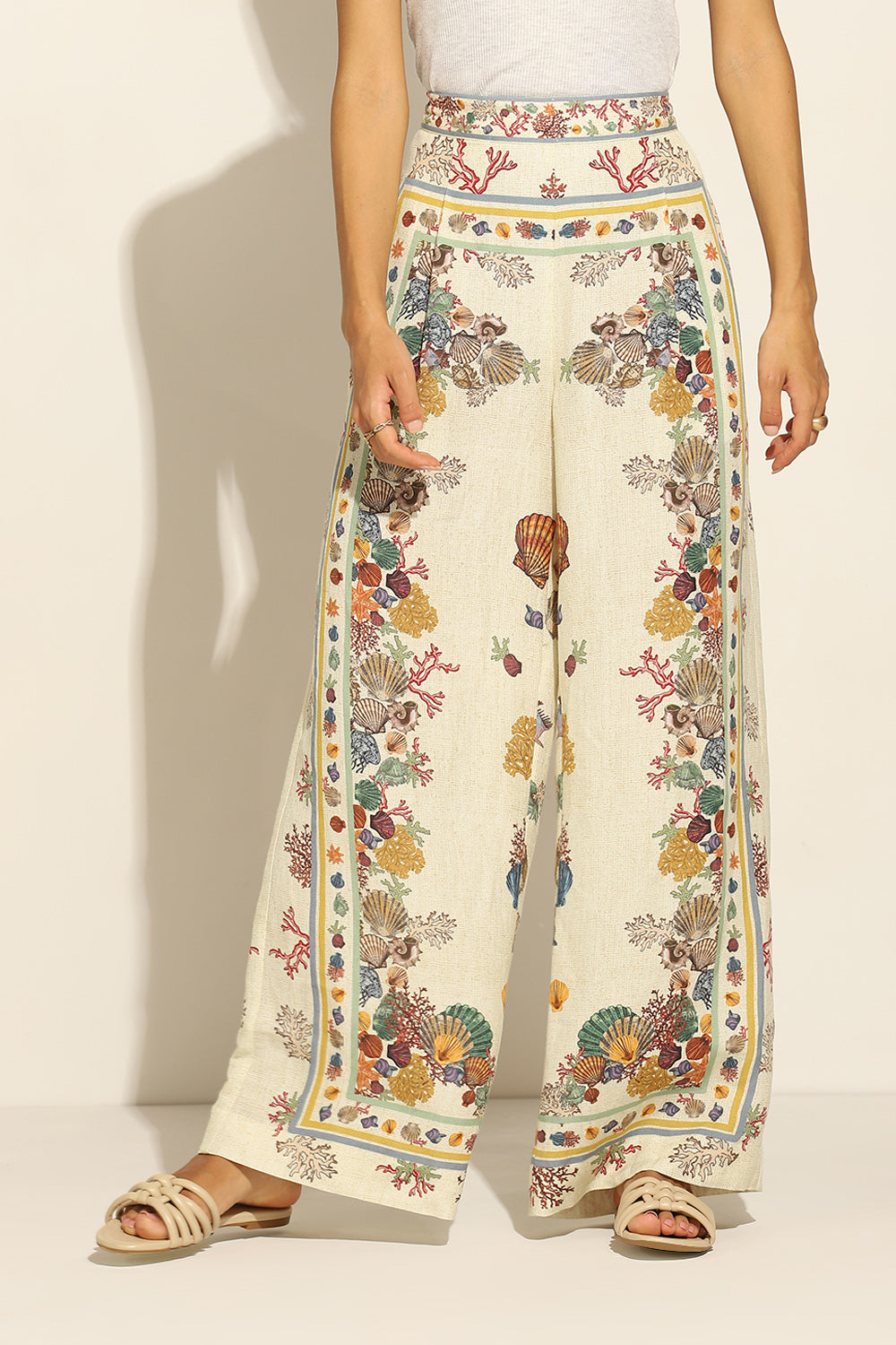 Ivory Wide Leg Pants by ranna gill with a floral and seashell pattern.