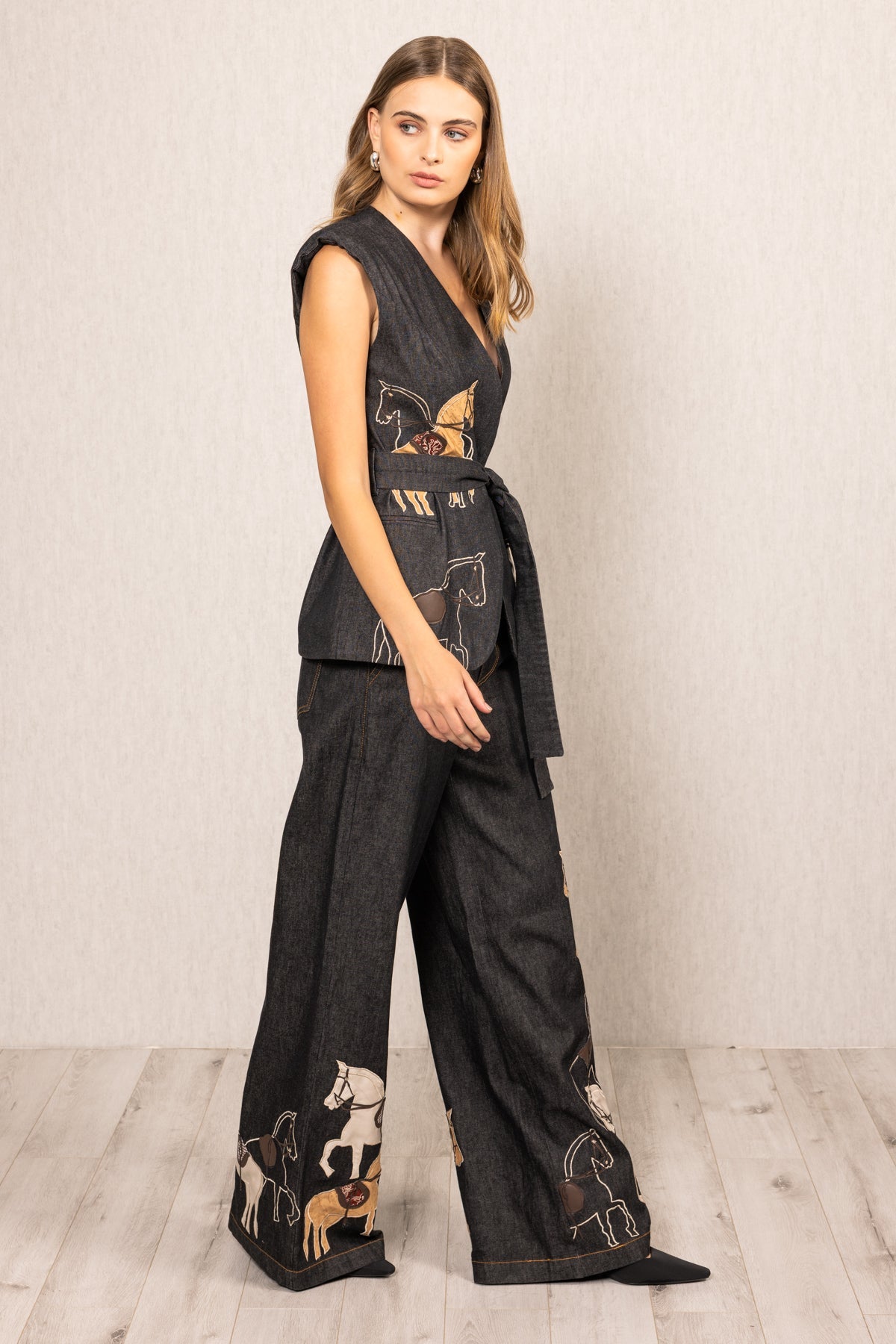 Ranna Gill Vega Belted Waist Coat in black denim with horse embroidery and tie-up belt.
