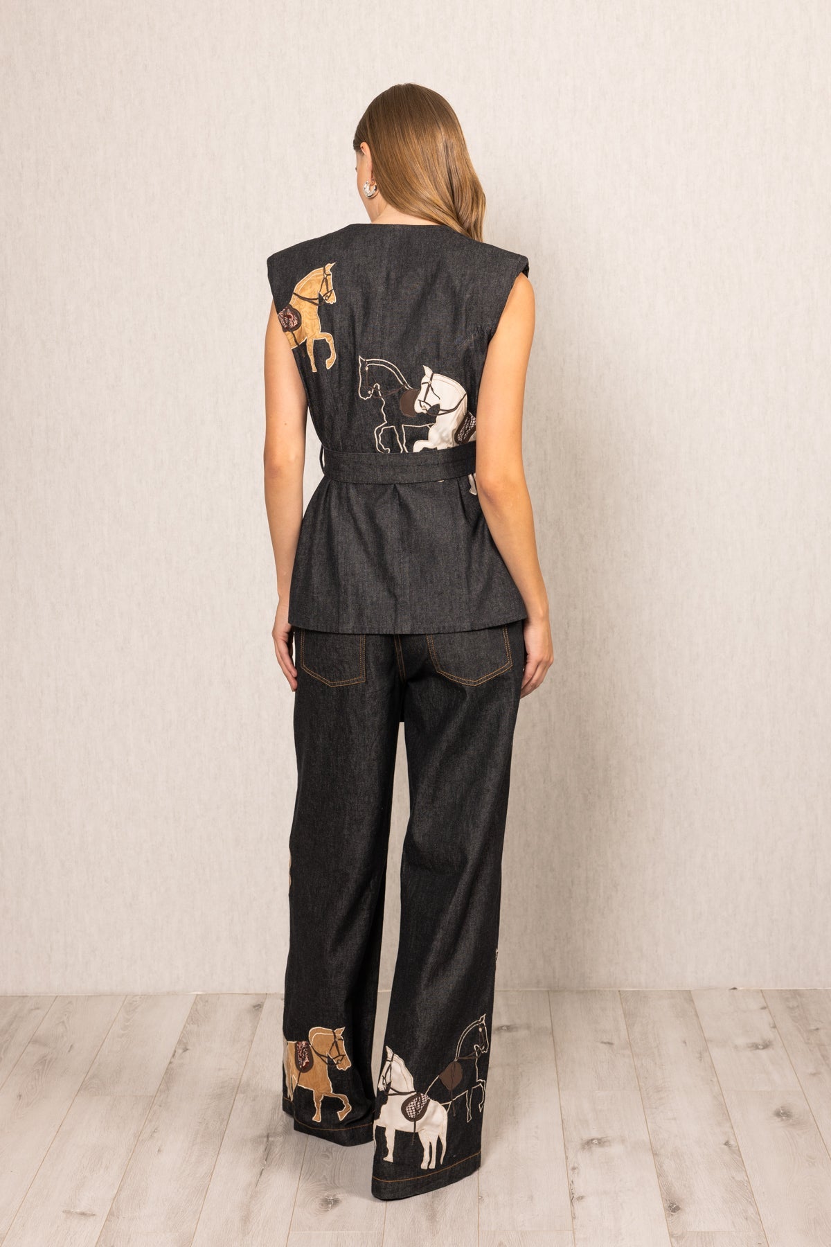 Ranna Gill Vega Belted Waist Coat in black denim with horse embroidery and tie-up belt.