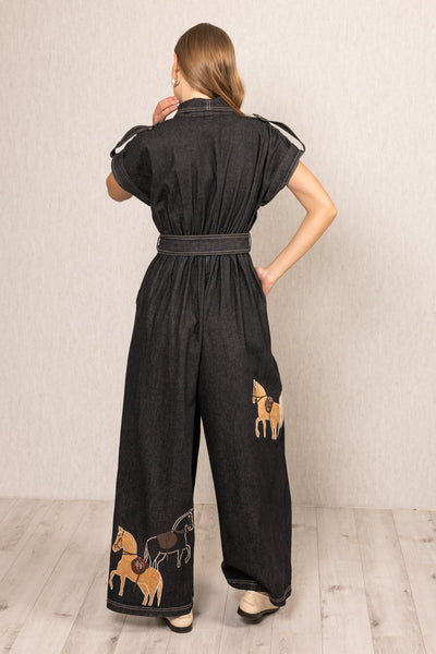 Phoenix Collared Jumpsuit in black denim with horse embroidery, belted waist, and wide-leg silhouette by Ranna Gill.