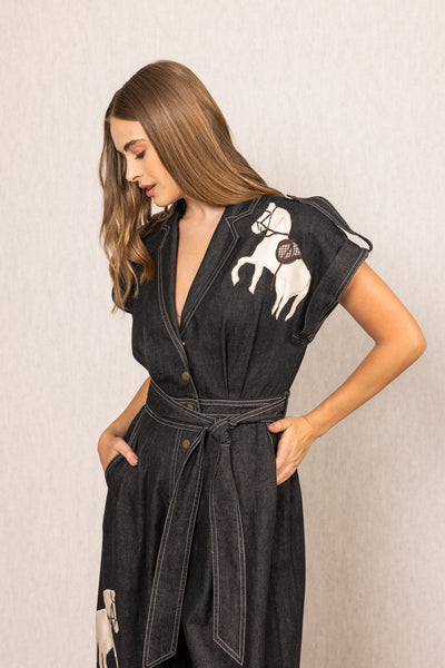 Ranna Gill Phoenix Collared Jumpsuit in black denim with horse embroidery, wide-leg silhouette, V-neckline, and belted waist