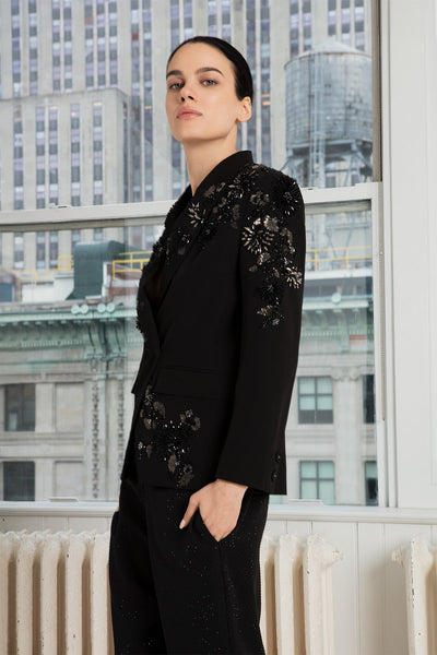 A black crepe blend jacket with long sleeves and a notched lapel collar, paired with trousers.