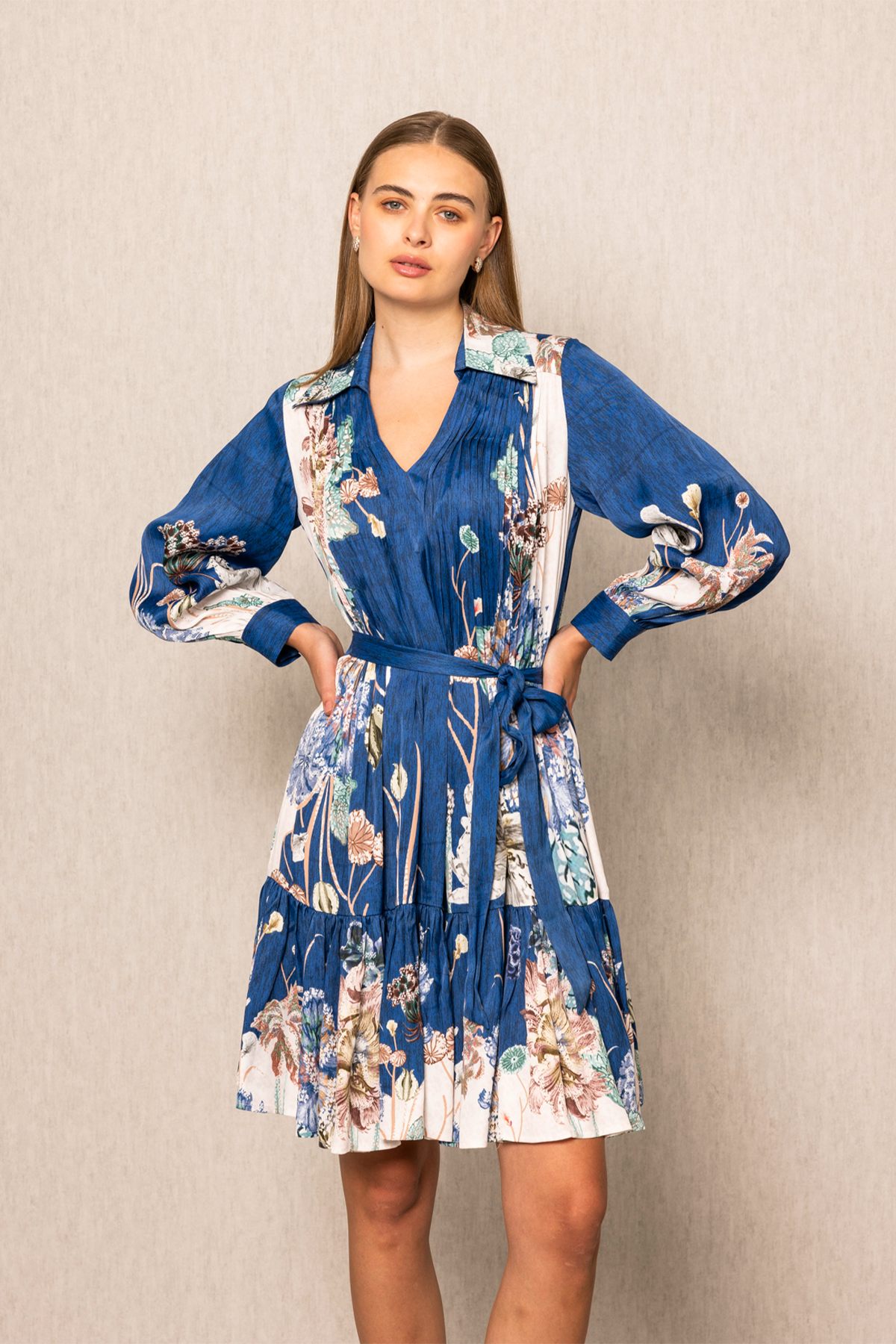 Ranna Gill Bluebell Pleated Dress in viscose satin Navy Blooms print with tiered pleats.