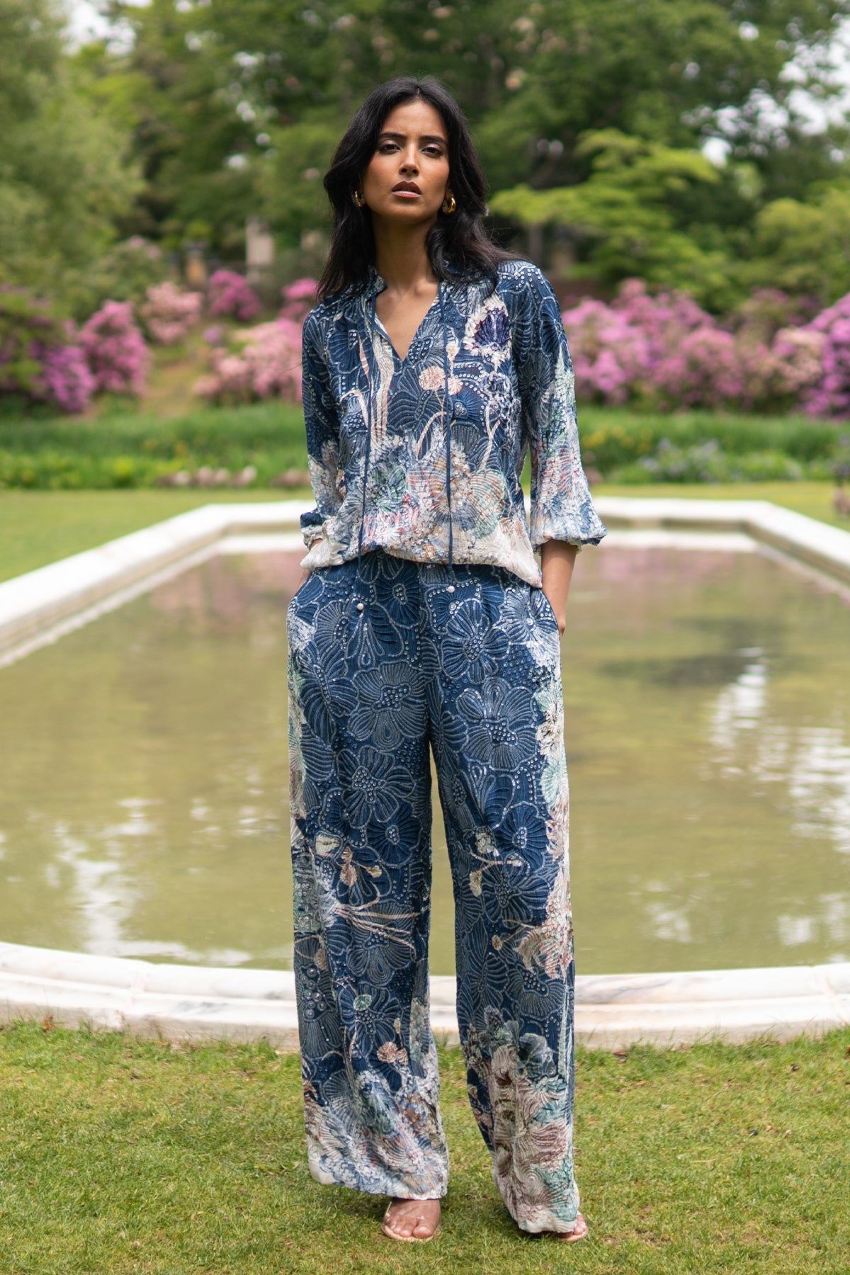 Ranna Gill Ibiza Blouse & Pant Set in Navy Blooms Floral print with tie-up blouse & wide-leg pants.
