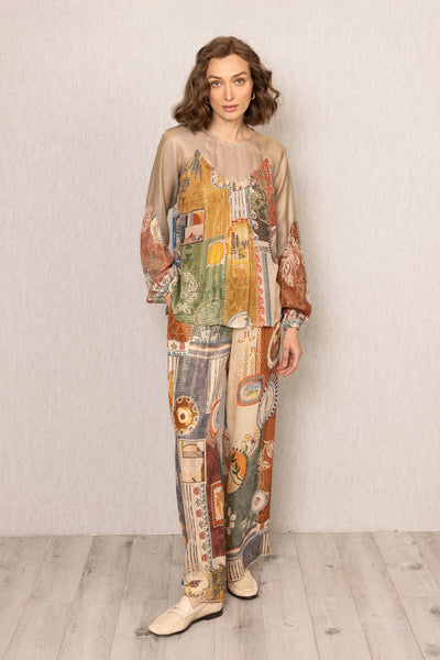 Woman wearing a patchwork outfit with a neutral background