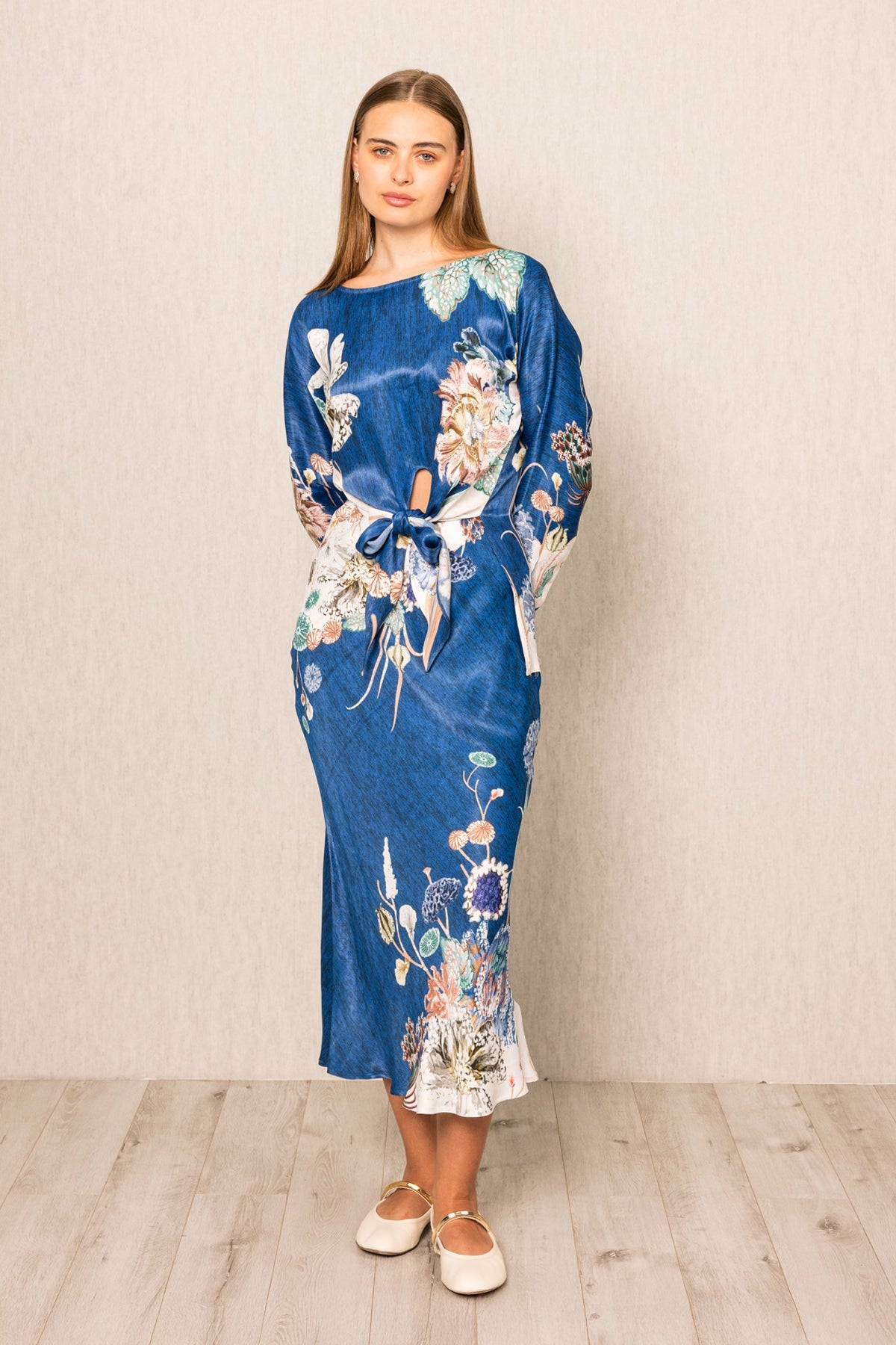 Valencia Front Tie Blouse and Skirt set, blue floral print midi dress with long sleeves, tie detail at waist, and white hem accent