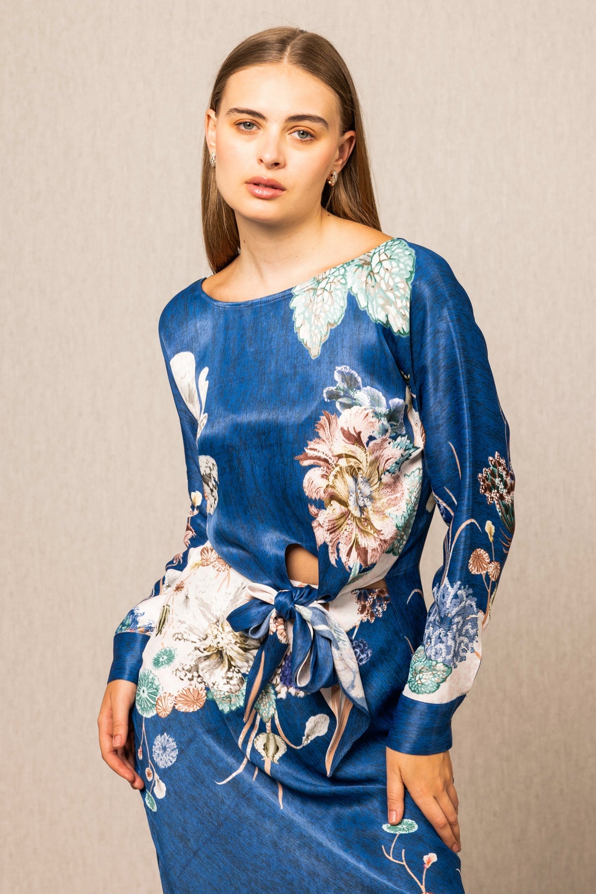 Valencia Front Tie Blouse and Skirt set, blue floral print midi dress with long sleeves, tie detail at waist, and white hem accent