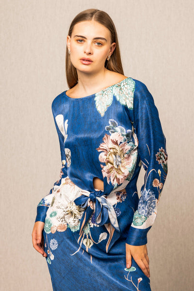 Valencia Front Tie Blouse and Skirt set, blue floral print midi dress with long sleeves, tie detail at waist, and white hem accent