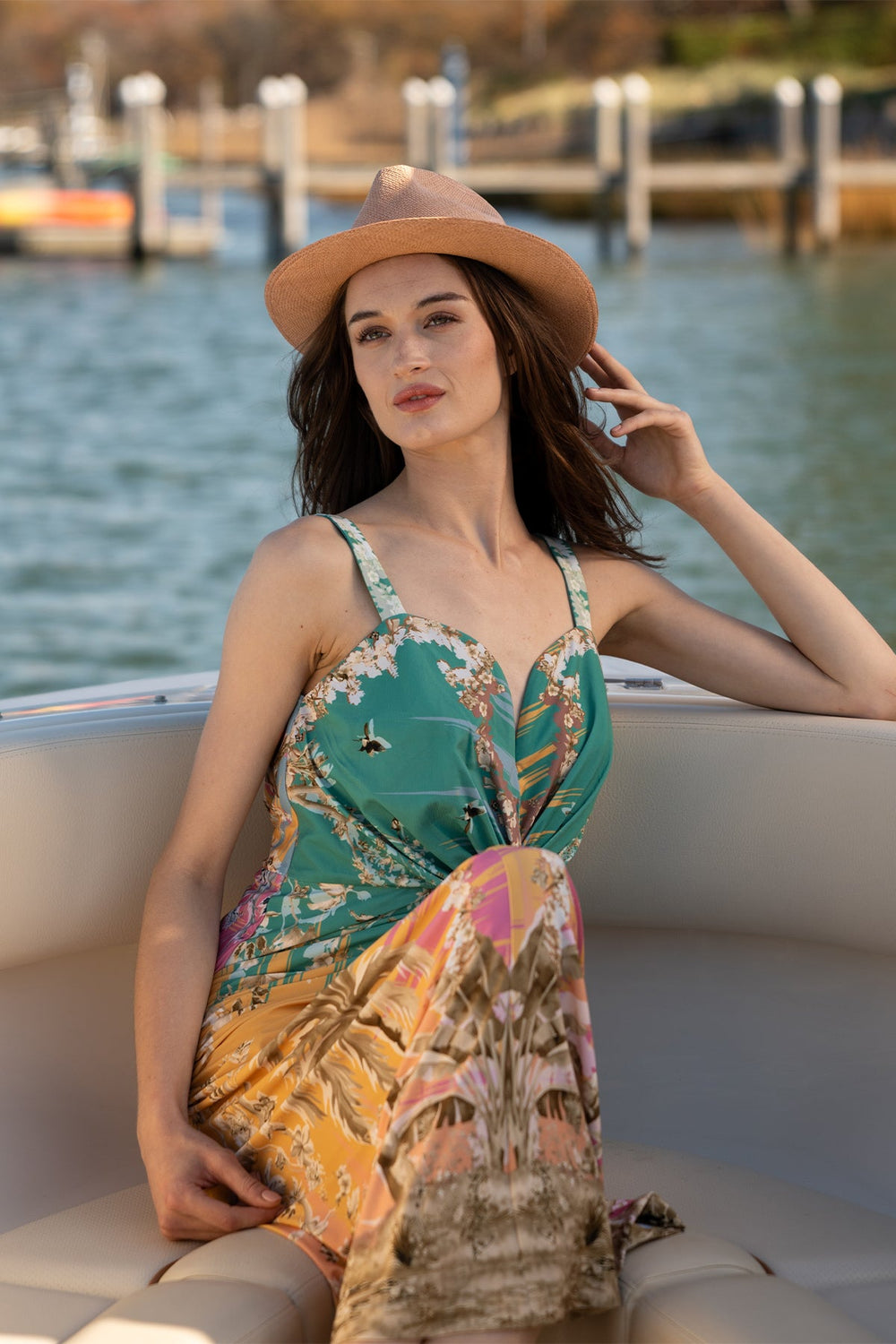 Ranna Gill Celeste Twisted Midi Dress a sleeveless, twisted midi dress with a palm beach print.