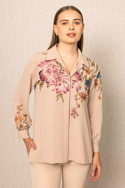 a beige blouse with floral embroidery