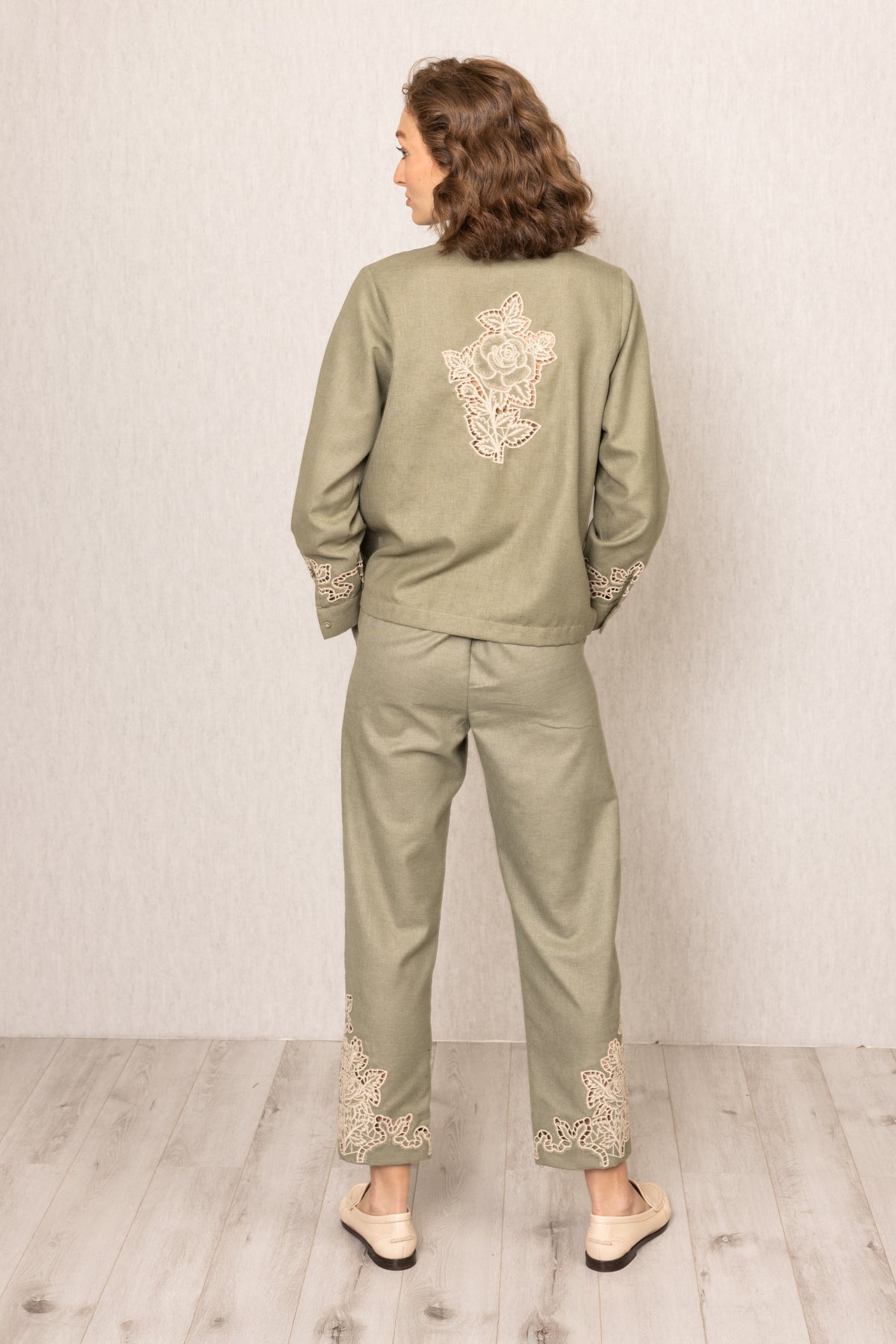 Sage green Raylen Rara Pants in Poly Flex with high waist, tapered legs, and tonal Schiffli embroidery on lower panels