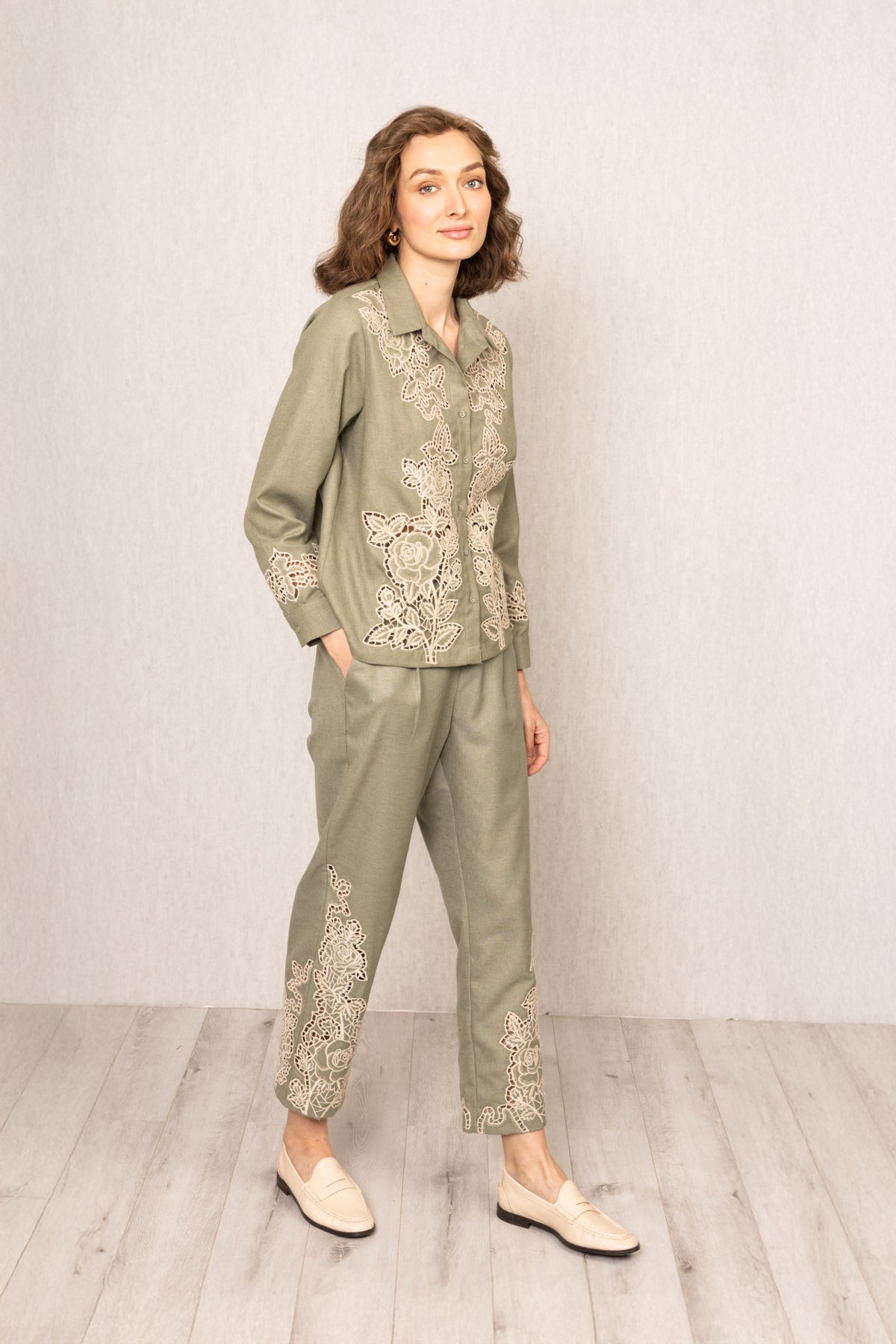 Sage green Raylen Rara Pants in Poly Flex with high waist, tapered legs, and tonal Schiffli embroidery on lower panels