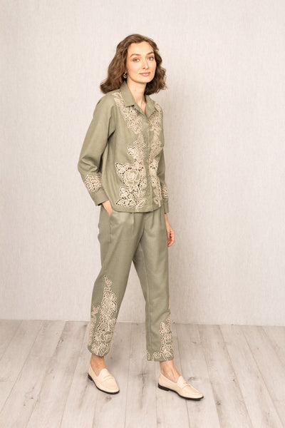 Sage green Raylen Rara Pants in Poly Flex with high waist, tapered legs, and tonal Schiffli embroidery on lower panels