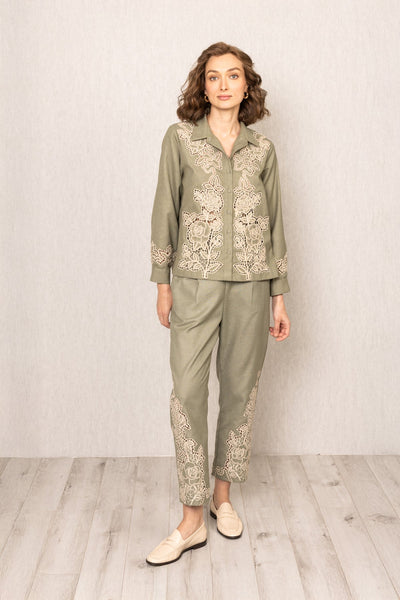 Sage green Raylen Rara Pants in Poly Flex with high waist, tapered legs, and tonal Schiffli embroidery on lower panels
