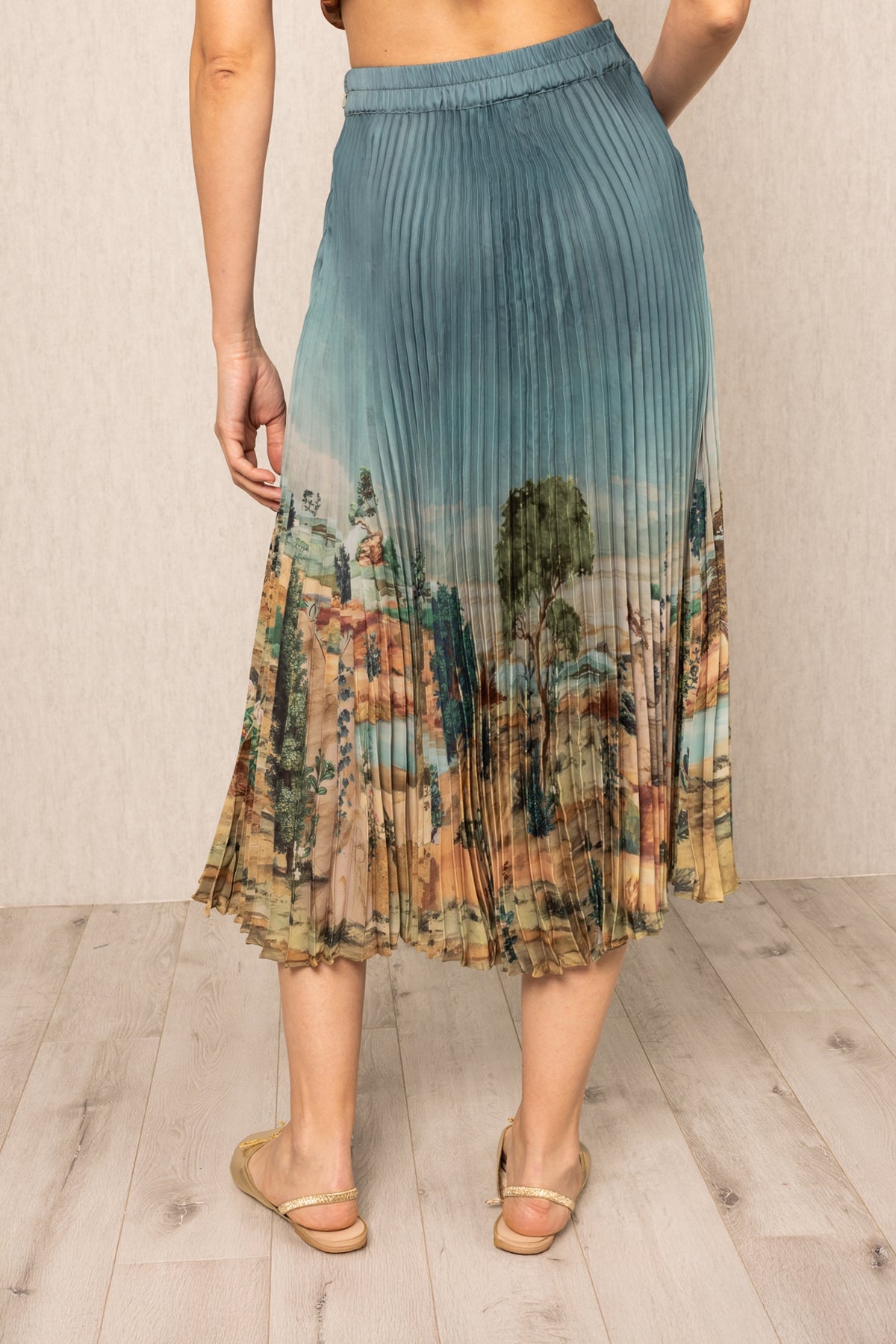 Ranna Gill Lyon Pleated Skirt in teal blue satin with Tuscany print and precision pleats.