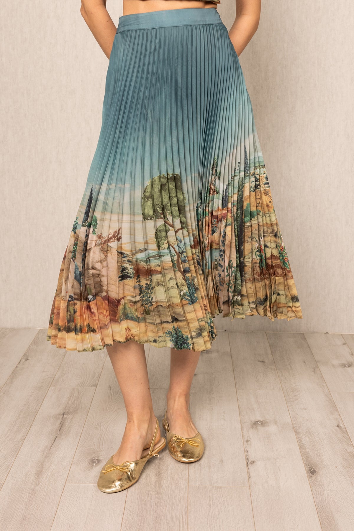 Ranna Gill Lyon Pleated Skirt in teal blue satin with Tuscany print and precision pleats.