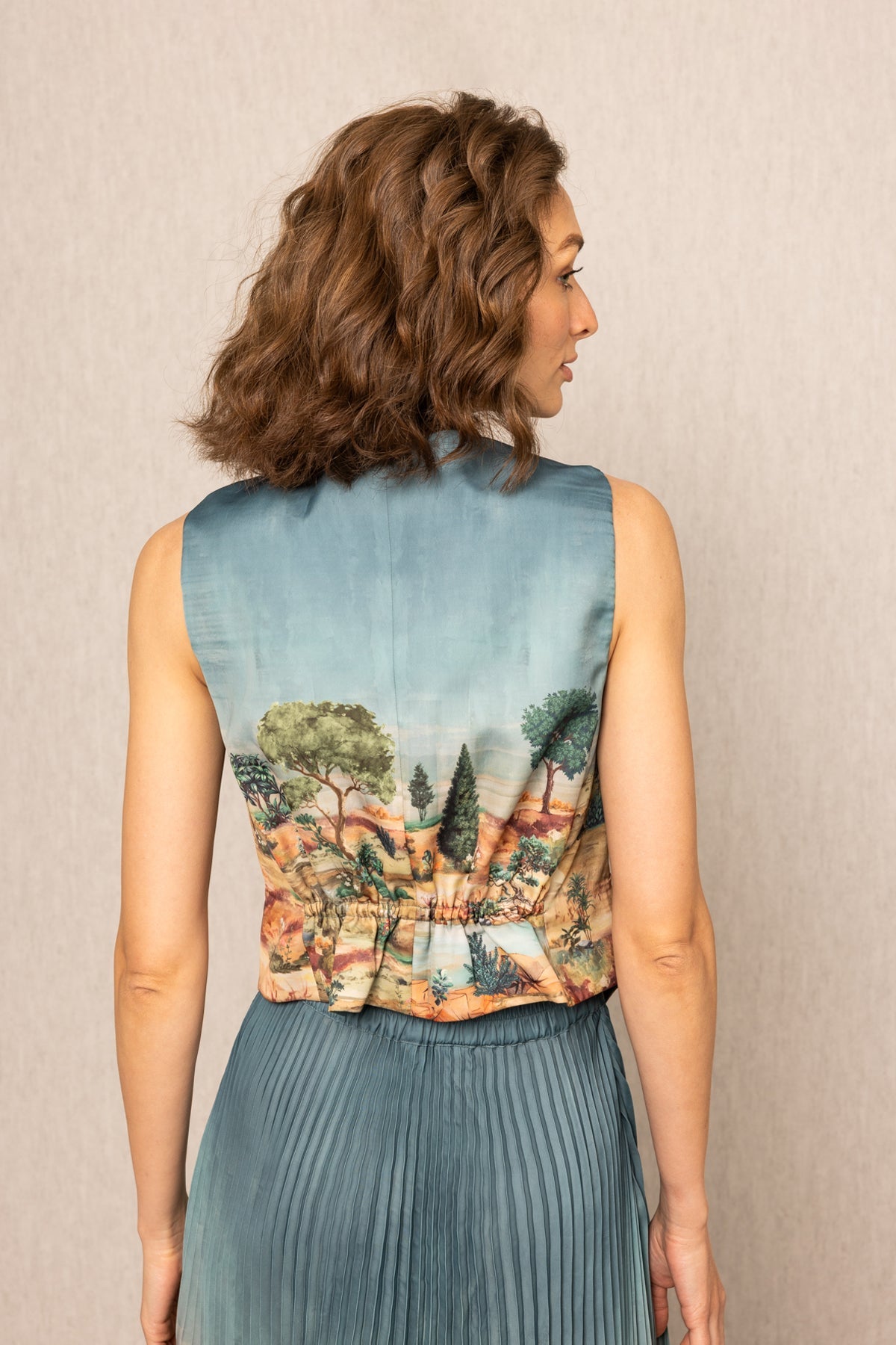 Ranna Gill Ibiza Waist Coat in teal blue satin with Tuscany print and button-down front.