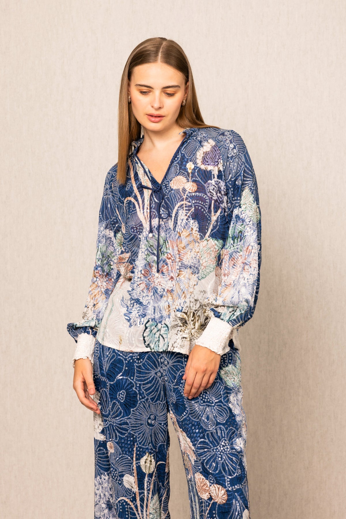Ranna Gill Ibiza Blouse & Pant Set in Navy Blooms Floral print with tie-up blouse & wide-leg pants.