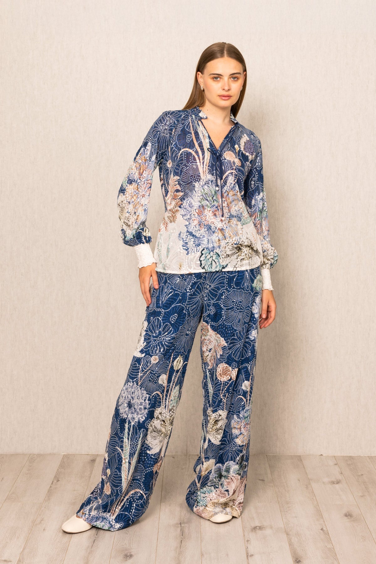 Ranna Gill Ibiza Blouse & Pant Set in Navy Blooms Floral print with tie-up blouse & wide-leg pants.