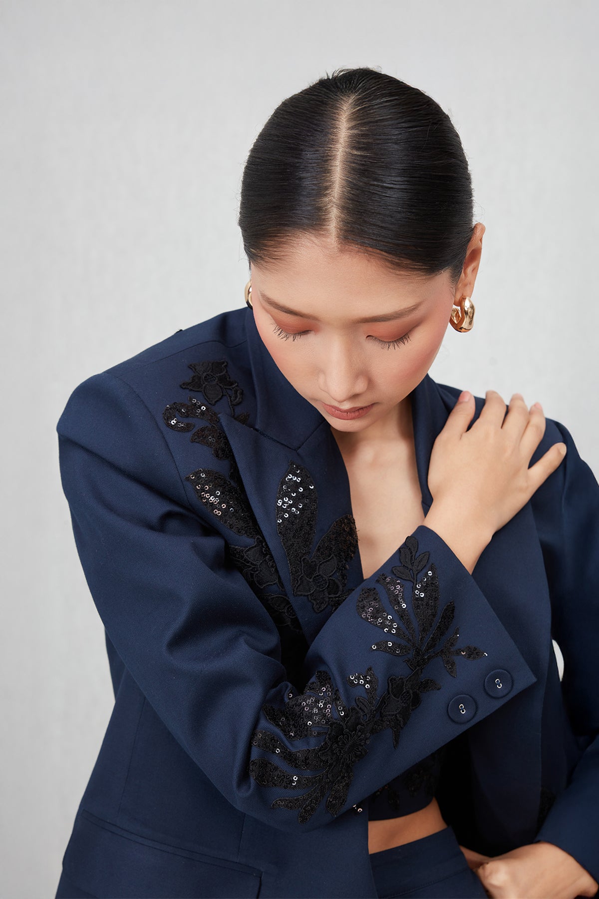 Ranna Gill Amara Oversized Jacket in navy blue cotton twill with Black floral sequin embroidery.