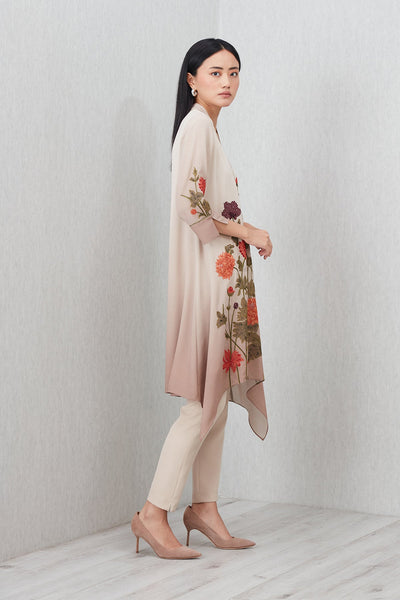Beige Azara Tunic by Ranna Gill with floral embroidery, V-neckline, 3/4 sleeves, and handkerchief hem.