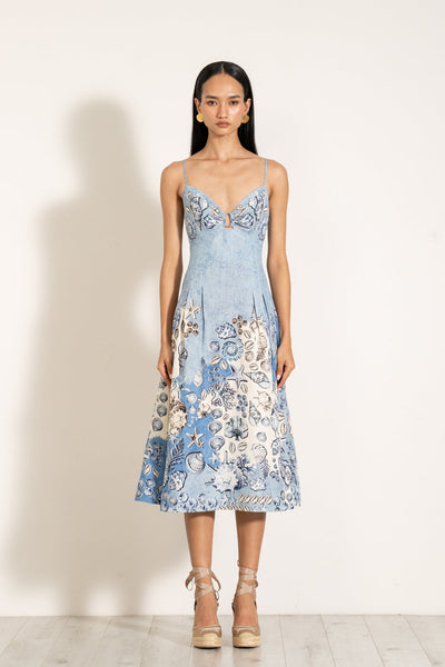 A sleeveless, pleated midi dress with a sweetheart neckline and a keyhole detail in a blue and white Atlantic print.