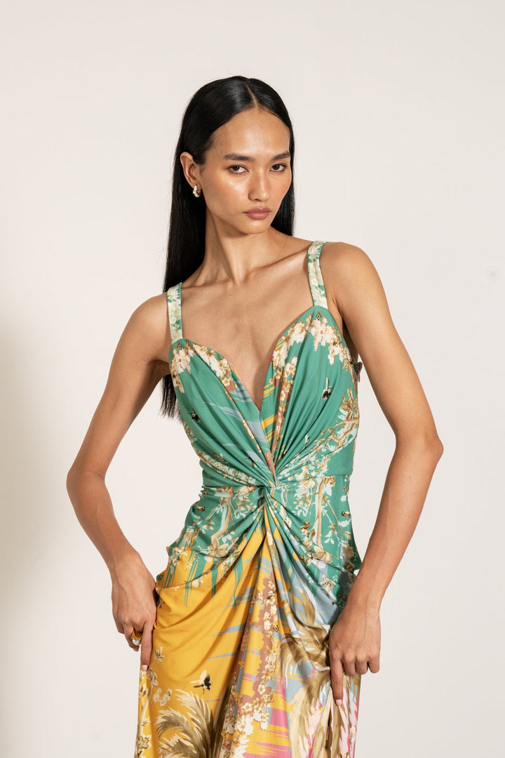 Ranna Gill Celeste Twisted Midi Dress a sleeveless, twisted midi dress with a palm beach print.