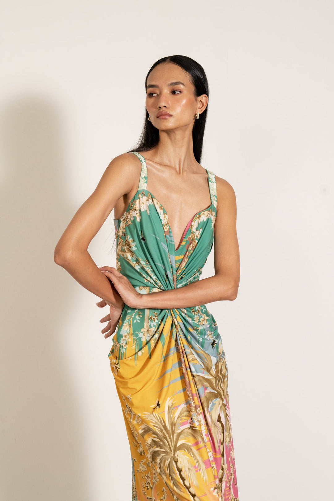 Ranna Gill Celeste Twisted Midi Dress a sleeveless, twisted midi dress with a palm beach print.