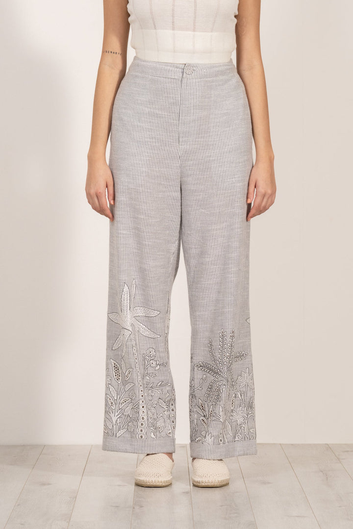 Verena high-waisted grey and white striped pants by ranna gill with aurora eyelet embroidery along the hemline.