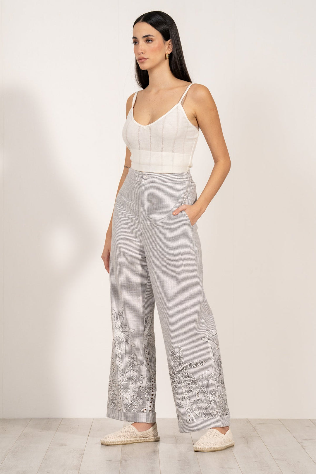 Verena high-waisted grey and white striped pants by ranna gill with aurora eyelet embroidery along the hemline.