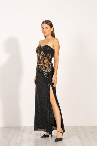 Aleysa Dress by Ranna Gill a black long dress with gold sequins and a thigh-high slit on the left side.