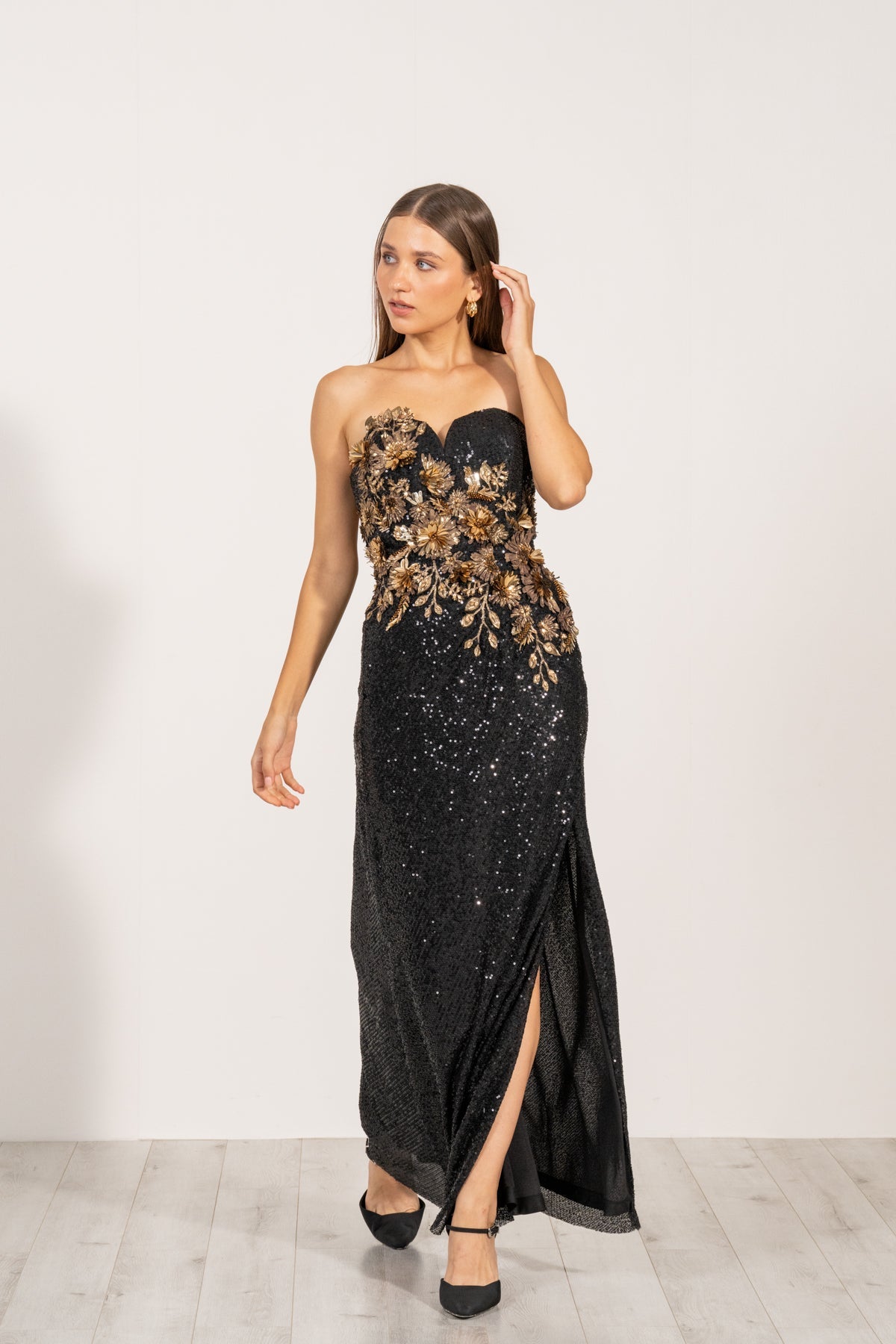 Aleysa Dress by Ranna Gill a black long dress with gold sequins and a thigh-high slit on the left side.